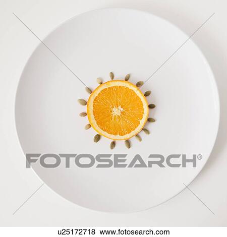Slice of orange and seeds on plate, studio shot View Large Photo Image Stock Photo - Slice of orange and seeds on plate, studio shot. Fotosearch