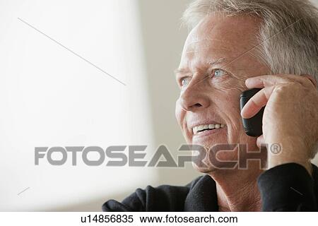Smiling senior man using mobile phone View Large Photo Image Stock Photography - Smiling senior man using mobile phone. Fotosearch
