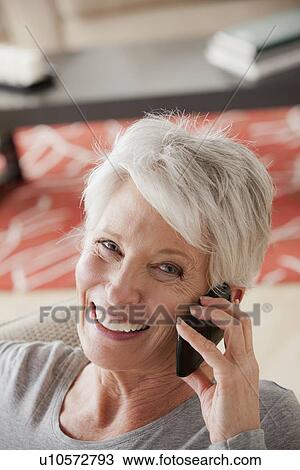 Smiling senior woman using mobile phone View Large Photo Image Stock Image - Smiling senior woman using mobile phone. Fotosearch