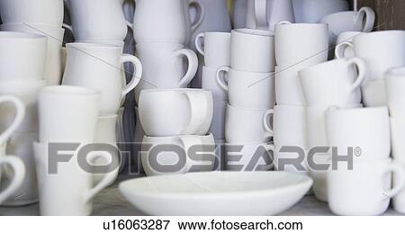 Stacked unfinished white pottery View Large Photo Image Stock Photo - Stacked unfinished white pottery. Fotosearch