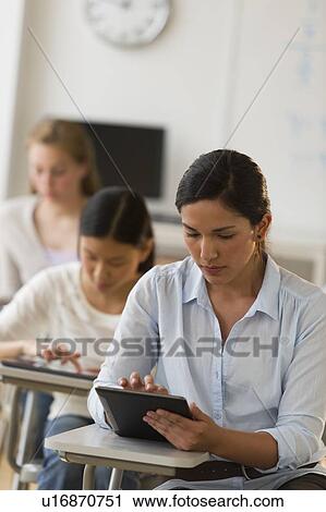 Stock Image - Students (14-19) using digital tablets. Fotosearch