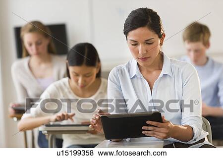 Stock Photo - Students (14-19) using digital tablets. Fotosearch