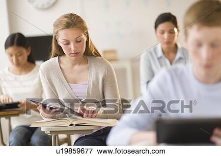 Students (14-19) using digital tablets at school View Large Photo Image Stock Photo - Students (14-19) using digital tablets at school. Fotosearch