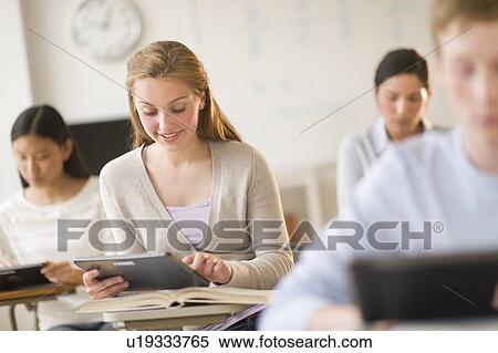 Students (14-19) using digital tablets at school View Large Photo Image Stock Photography - Students (14-19) using digital tablets at school. Fotosearch