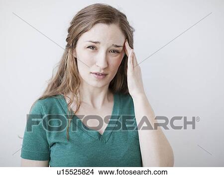 Studio shot of young suffering from headache View Large Photo Image Picture - Studio shot of young suffering from headache. Fotosearch