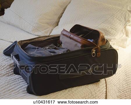 Suitcase on bed View Large Photo Image Stock Photo - Suitcase on bed. Fotosearch