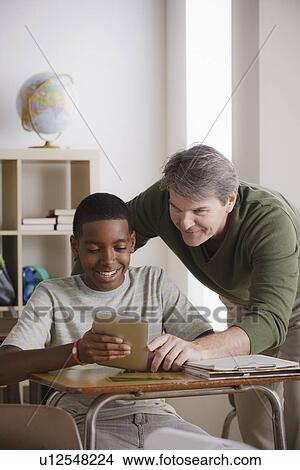 Picture - Teacher and schoolboy (14-15). Fotosearch