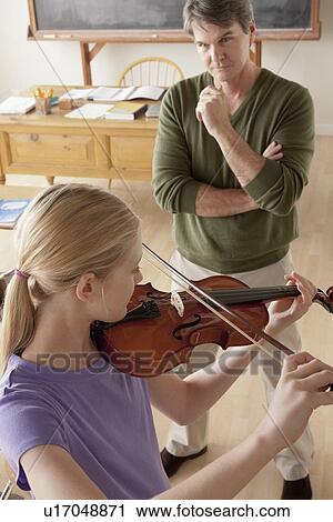 Teacher and teenage girl (14-15) playing violin View Large Photo Image Stock Image - Teacher and teenage girl (14-15) playing violin. Fotosearch
