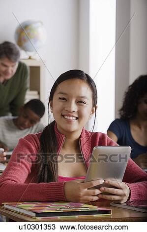 Stock Image - Teacher and teenage students (14-15, 16-17). Fotosearch