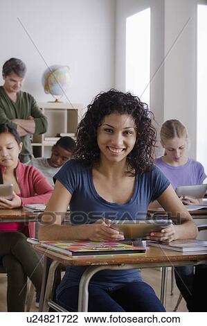 Stock Image - Teacher and teenage students (14-15, 16-17). Fotosearch
