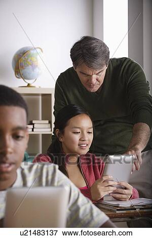 Stock Photo - Teacher and teenage students (14-15). Fotosearch