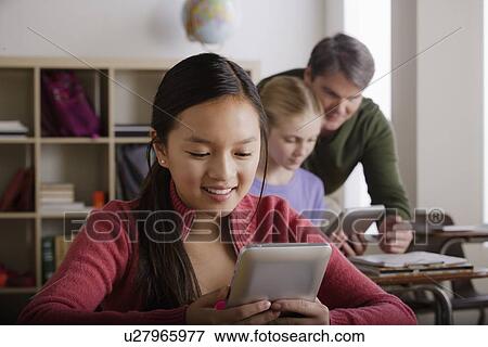 Stock Photo - Teacher and teenage students (14-15). Fotosearch