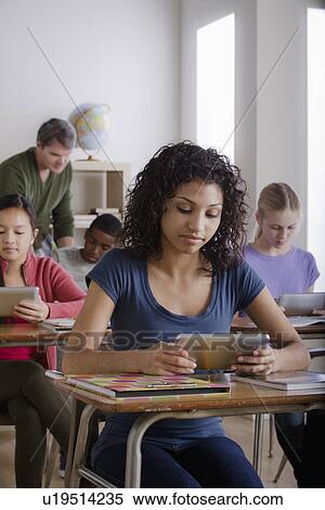 Stock Photography - Teacher and teenage students (14-15, 16-17). Fotosearch