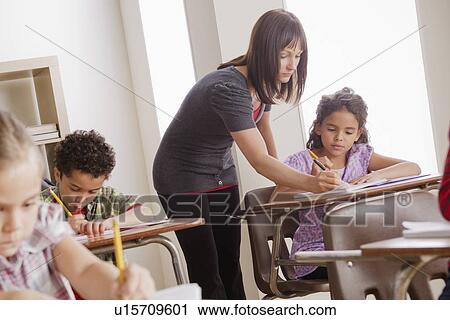 Teacher helping schoolchildren (6-7, 8-9) View Large Photo Image Stock Image - Teacher helping schoolchildren (6-7, 8-9). Fotosearch