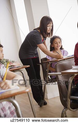 Teacher helping schoolchildren (6-7, 8-9) View Large Photo Image Stock Image - Teacher helping schoolchildren (6-7, 8-9). Fotosearch