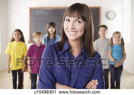 Teacher with group of pupils in front of blackboard View Large Photo Image Stock Image - Teacher with group of pupils in front of blackboard. Fotosearch