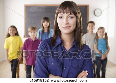 Teacher with group of pupils in front of blackboard View Large Photo Image Stock Image - Teacher with group of pupils in front of blackboard. Fotosearch