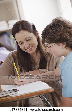 Stock Image - Teacher with schoolboy (10-11). Fotosearch