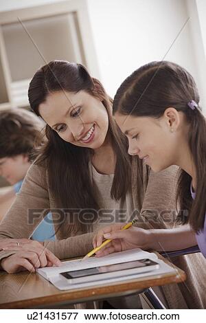 Stock Photo - Teacher with schoolgirl (12-13). Fotosearch