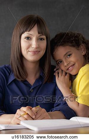 Stock Photography - Teacher with smiling schoolgirl. Fotosearch
