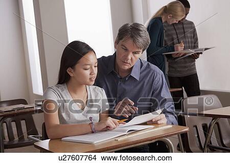 Teacher with teenage students (14-15) at school View Large Photo Image Picture - Teacher with teenage students (14-15) at school. Fotosearch