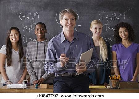 Teacher with teenage students (14-15, 16-17) at school View Large Photo Image Stock Image - Teacher with teenage students (14-15, 16-17) at school. Fotosearch