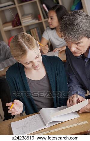 Teacher with teenage students (14-15) at school View Large Photo Image Stock Photo - Teacher with teenage students (14-15) at school. Fotosearch