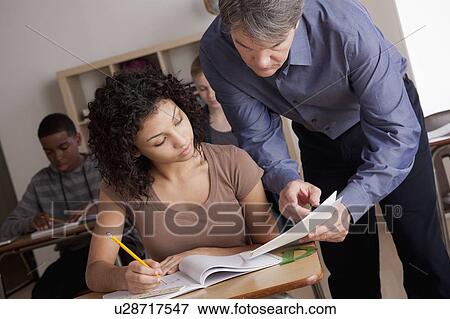 Teacher with teenage students (14-15, 16-17) at school View Large Photo Image Stock Photo - Teacher with teenage students (14-15, 16-17) at school. Fotosearch
