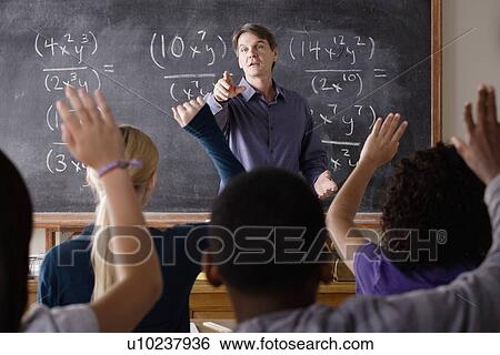 Stock Photograph - Teacher with teenage students (14-15, 16-17) at school. Fotosearch