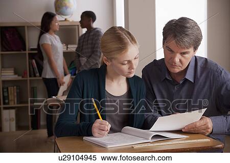 Stock Photography - Teacher with teenage students (14-15) at school. Fotosearch