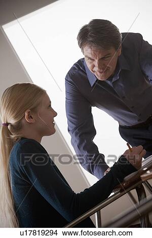 Picture - Teenage girl (14-15) with teacher at school. Fotosearch