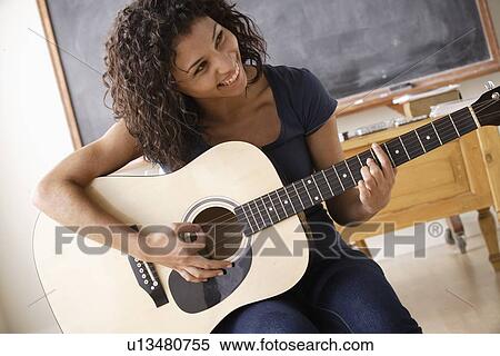 Teenage girl (16-17) playing guitar View Large Photo Image Stock Photography - Teenage girl (16-17) playing guitar. Fotosearch