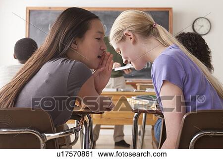 Teenage girls (14-15, 16-17) whispering in classroom View Large Photo Image Stock Image - Teenage girls (14-15, 16-17) whispering in classroom. Fotosearch