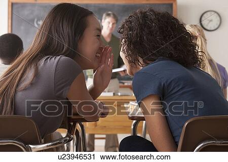 Teenage girls (14-15, 16-17) whispering in classroom View Large Photo Image Stock Image - Teenage girls (14-15, 16-17) whispering in classroom. Fotosearch