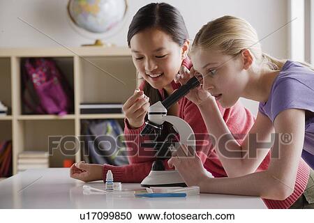 Teenage girls (14-15) working with microscope View Large Photo Image Stock Image - Teenage girls (14-15) working with microscope. Fotosearch