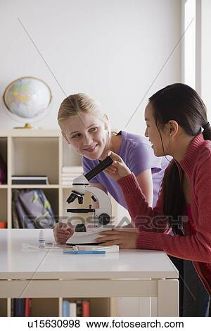 Teenage girls (14-15) working with microscope View Large Photo Image Stock Photo - Teenage girls (14-15) working with microscope. Fotosearch