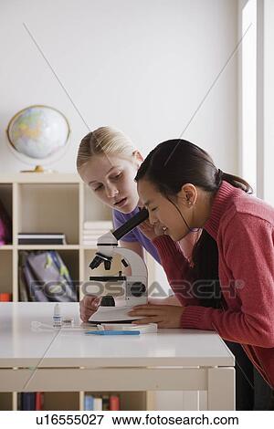 Teenage girls (14-15) working with microscope View Large Photo Image Stock Photo - Teenage girls (14-15) working with microscope. Fotosearch
