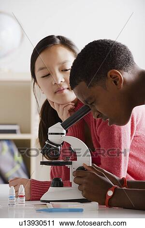 Teenage students (14-15) working with microscope View Large Photo Image Stock Image - Teenage students (14-15) working with microscope. Fotosearch