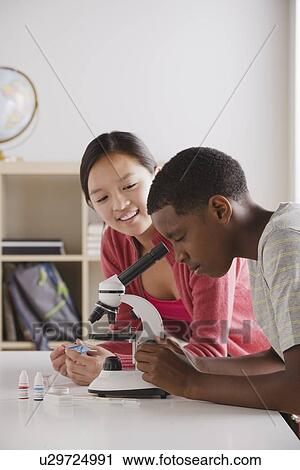 Teenage students (14-15) working with microscope View Large Photo Image Stock Image - Teenage students (14-15) working with microscope. Fotosearch