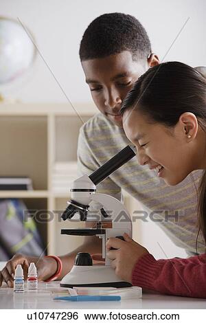 Teenage students (14-15) working with microscope View Large Photo Image Stock Photograph - Teenage students (14-15) working with microscope. Fotosearch