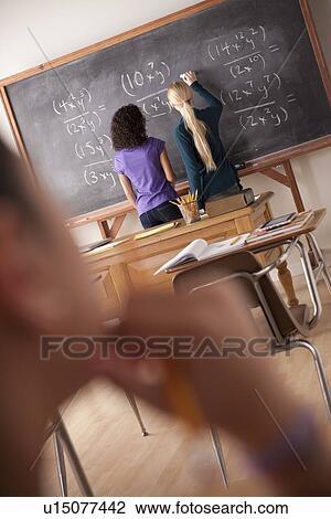 Stock Image - Teenagers (14-15, 16-17) at school. Fotosearch