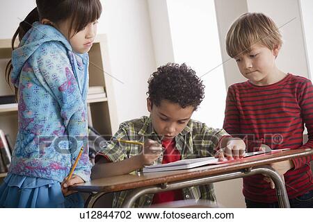 Three children (6-7, 8-9) at school View Large Photo Image Stock Image - Three children (6-7, 8-9) at school. Fotosearch