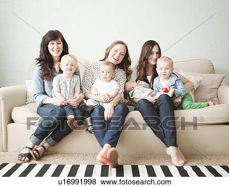 Three young mothers with toddler girl (2-3) and tow baby boys (2-5 months, 6-11 months) posing for portrait View Large Photo Image Stock Photo - Three young mothers with toddler girl (2-3) and tow baby boys (2-5 months, 6-11 months) posing for portrait. Fotosearch