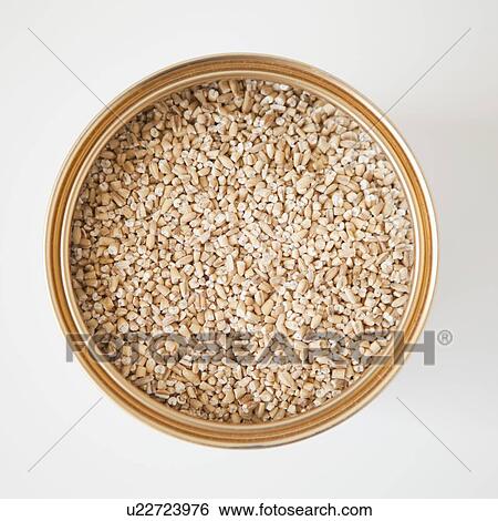 Stock Photograph - Tin with wheat inside, studio shot. Fotosearch