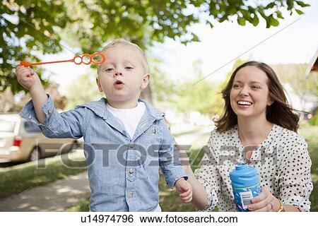 Toddler boy (2-3) and mother blowing bubbles View Large Photo Image Stock Photograph - Toddler boy (2-3) and mother blowing bubbles. Fotosearch