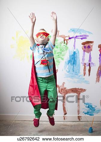 Toddler boy (2-3) in superhero costume jumping mid-air View Large Photo Image Stock Image - Toddler boy (2-3) in superhero costume jumping mid-air. Fotosearch