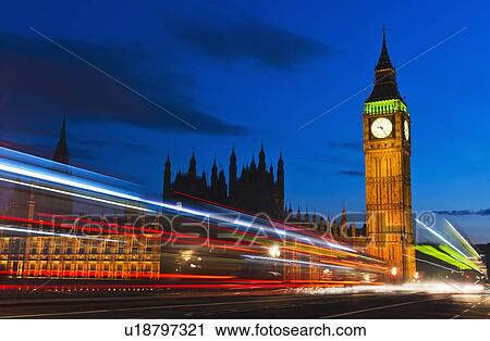 Stock Image - UK, England, London, Big Ben and light trails at night. Fotosearch