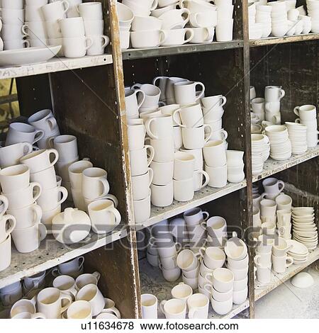 Unfinished jugs on shelves in pottery warehouse View Large Photo Image Stock Photo - Unfinished jugs on shelves in pottery warehouse. Fotosearch