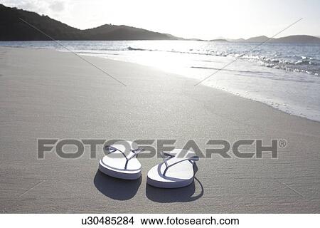 Picture - United States Virgin Islands, St. John, Pair of flip flops left on empty beach. Fotosearch