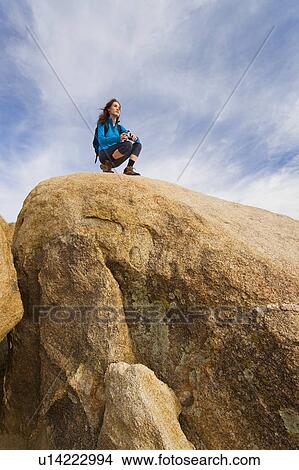 Picture - USA, California, Joshua Tree National Park, Female hiker on rocks. Fotosearch
